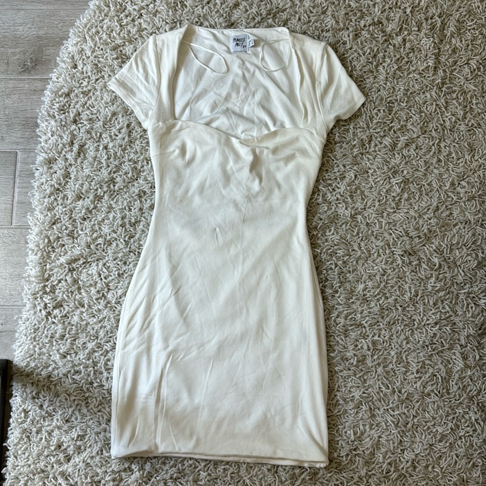 White dress, sweetheart neckline, open space in back with tie